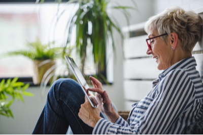 woman smiling on tablet