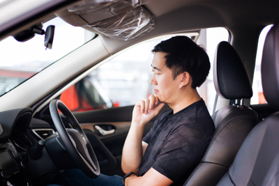 man in car wondering if it's time to sell